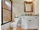 Bright bathroom featuring a shower over tub, white vanity, and decorative mirror at 2450 Weber Heights Way, Buford, GA 30519