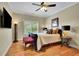 Comfortable bedroom with hardwood floors, TV, and a ceiling fan for year-round comfort at 2450 Weber Heights Way, Buford, GA 30519