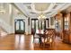Open dining area with hardwood floors, coffered ceiling, chandelier, and large windows at 2450 Weber Heights Way, Buford, GA 30519