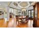 Elegant dining room with a coffered ceiling, hardwood floors, and an antique china cabinet at 2450 Weber Heights Way, Buford, GA 30519