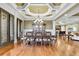 Elegant dining room featuring hardwood floors, a decorative ceiling, and a stylish chandelier at 2450 Weber Heights Way, Buford, GA 30519