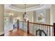 Foyer with a hardwood staircase with elegant railing, a view of the front door, and beautiful chandelier at 2450 Weber Heights Way, Buford, GA 30519