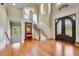 Grand foyer with a staircase, hardwood floors, high ceilings, and a decorative front door at 2450 Weber Heights Way, Buford, GA 30519
