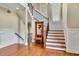 Elegant foyer featuring hardwood floors, staircase with iron railings, and detailed trim work at 2450 Weber Heights Way, Buford, GA 30519