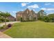 Beautiful two-story brick home on a landscaped lawn with a symmetrical layout and a charming driveway at 2450 Weber Heights Way, Buford, GA 30519