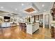 Large open kitchen with a center island, stainless appliances, and a view into the living space at 2450 Weber Heights Way, Buford, GA 30519
