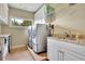 Functional laundry room equipped with a washer, dryer, countertop, sink, and cabinet storage at 2450 Weber Heights Way, Buford, GA 30519