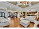 Open concept living area with hardwood floors seamlessly connects kitchen, dining, and living spaces at 2450 Weber Heights Way, Buford, GA 30519
