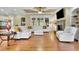 Comfortable living room showcasing hardwood floors, a fireplace, and a large, white sectional sofa at 2450 Weber Heights Way, Buford, GA 30519