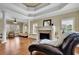 Bright living room with elegant columns, coffered ceilings, and a fireplace with decorative mantle at 2450 Weber Heights Way, Buford, GA 30519