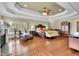 Spacious main bedroom featuring tray ceilings, a fireplace, and a seating area with chaise lounge at 2450 Weber Heights Way, Buford, GA 30519