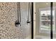 Close up of a modern shower with dual shower heads and a mosaic tiled accent wall at 2450 Weber Heights Way, Buford, GA 30519
