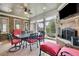Inviting sunroom features a brick fireplace, large windows, and a tile floor at 2450 Weber Heights Way, Buford, GA 30519