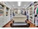 Large walk-in closet with custom shelving, drawers, and a central island for organizing clothes at 2450 Weber Heights Way, Buford, GA 30519