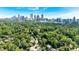 Stunning aerial view of a lush neighborhood with the Atlanta skyline as a backdrop on a clear day at 251 Beverly Ne Rd, Atlanta, GA 30309