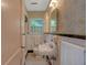 Bathroom features period sink and mirror and patterned wall and floor tiles at 251 Beverly Ne Rd, Atlanta, GA 30309
