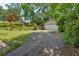Long, paved driveway leading to a detached garage with landscaped surroundings at 251 Beverly Ne Rd, Atlanta, GA 30309