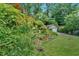 Beautifully landscaped front yard featuring lush greenery, flowers, and a detached garage at 251 Beverly Ne Rd, Atlanta, GA 30309