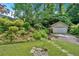 Charming front yard featuring terraced landscaping, lush greenery and a detached garage at 251 Beverly Ne Rd, Atlanta, GA 30309