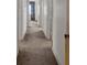 Long hallway with neutral carpet and paint leading to rooms throughout the house at 251 Beverly Ne Rd, Atlanta, GA 30309