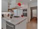 Compact kitchen with white cabinets, built-in microwave, and island at 251 Beverly Ne Rd, Atlanta, GA 30309