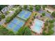 Aerial view of community tennis courts and pool with mature trees, offering recreational amenities at 4434 Austin Hills Dr, Suwanee, GA 30024