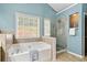 Bathroom featuring a large tub and glass enclosed shower at 4434 Austin Hills Dr, Suwanee, GA 30024