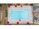 Overhead view of a community pool with ample seating, umbrellas, and a playground nearby at 4434 Austin Hills Dr, Suwanee, GA 30024