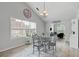 Bright dining area with large windows, a glass table, and a view into the living room, bathed in natural light at 4434 Austin Hills Dr, Suwanee, GA 30024
