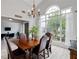 Elegant dining room featuring a large arched window, a chandelier, and a wooden table with seating for six at 4434 Austin Hills Dr, Suwanee, GA 30024