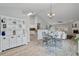 Bright dining area with a glass-topped table, white hutch, and open access to the living room and kitchen at 4434 Austin Hills Dr, Suwanee, GA 30024