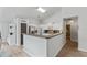 Bright kitchen featuring white cabinets, stainless steel appliances, breakfast bar, and hardwood floors at 4434 Austin Hills Dr, Suwanee, GA 30024