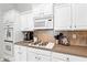 Kitchen features stainless appliances, gas cooktop, tile backsplash, and ample cabinet space at 4434 Austin Hills Dr, Suwanee, GA 30024