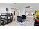Open-concept living room with vaulted ceilings, contemporary furniture, a vintage arcade game, and a sleek bar area at 4434 Austin Hills Dr, Suwanee, GA 30024