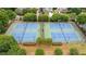 Aerial view of tennis courts surrounded by lush greenery in a residential community at 4434 Austin Hills Dr, Suwanee, GA 30024