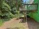 A cozy backyard view with a wooden deck above, complemented by natural landscaping at 5760 Windermere Ct, Lithonia, GA 30038
