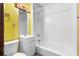 Bright bathroom featuring a vanity, mirror, and a shower-tub with a white surround at 5760 Windermere Ct, Lithonia, GA 30038
