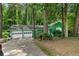 Charming green two-car garage home nestled among mature trees offering natural light and privacy at 5760 Windermere Ct, Lithonia, GA 30038