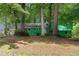 Exterior view of a unique home with a garage and verdant surrounding trees at 5760 Windermere Ct, Lithonia, GA 30038
