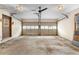 Unfinished two car garage with two garage doors, a side door, and fluorescent lighting at 5760 Windermere Ct, Lithonia, GA 30038