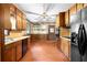 Traditional eat-in kitchen featuring wooden cabinetry, laminate countertops, and vintage details at 5760 Windermere Ct, Lithonia, GA 30038
