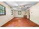 Spacious living room features a ceiling fan, wood floors, and windows providing natural light at 5760 Windermere Ct, Lithonia, GA 30038