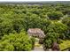Majestic home nestled among lush trees, showcasing its grandeur and the serene natural surroundings from an aerial perspective at 912 Chipley Ct, Marietta, GA 30062