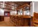 Custom basement bar with wood bar, seating, hardwood floors and an intricately designed copper-tone ceiling at 912 Chipley Ct, Marietta, GA 30062