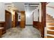Basement sitting area with wine storage, hardwood floors, paneled walls, and staircase at 912 Chipley Ct, Marietta, GA 30062