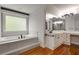 Bright bathroom includes a soaking tub, hardwood floors, and vanity area at 912 Chipley Ct, Marietta, GA 30062