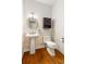 Elegant powder room features a pedestal sink, decorative fixtures, and hardwood floors at 912 Chipley Ct, Marietta, GA 30062