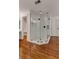 Bathroom with glass enclosed shower with black trim and hardware, hardwood flooring, and doorways at 912 Chipley Ct, Marietta, GA 30062