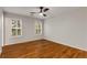 Bright bedroom features hardwood floors, a ceiling fan, and shuttered windows at 912 Chipley Ct, Marietta, GA 30062