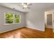 Bright bedroom with hardwood floors, ceiling fan, and a view to the ensuite bathroom at 912 Chipley Ct, Marietta, GA 30062